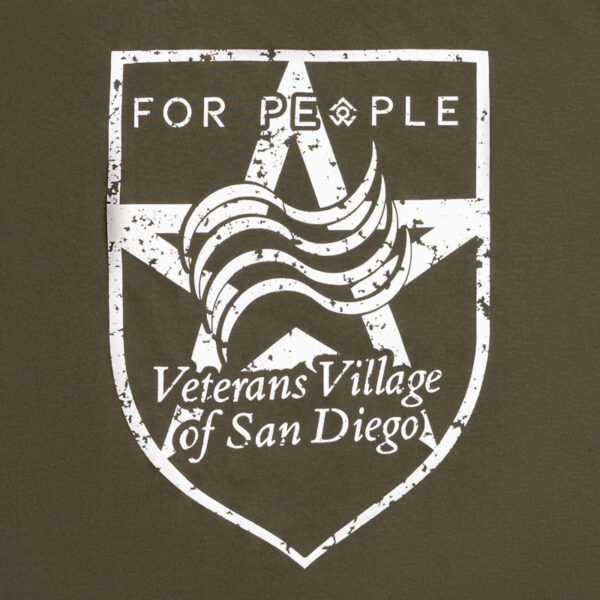 A photo of a green shirt with "For People" and "Veterans Village of San Diego" written over a star logo closeup on the logo