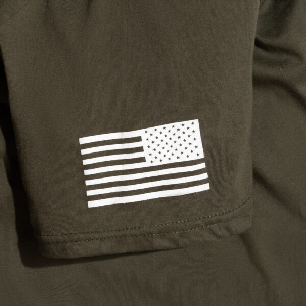 A photo of a green shirt with "For People" and "Veterans Village of San Diego" written over a star logo sleeve american flag