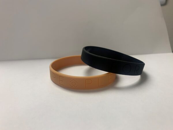 Two rubber For People bracelets, one black and one orange