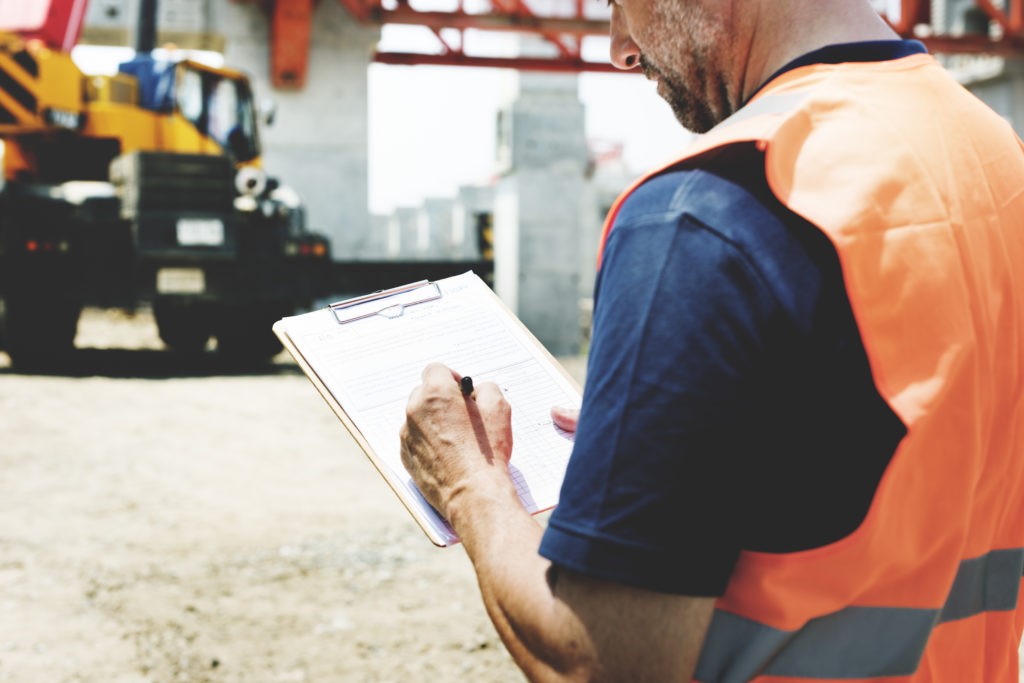 construction worker with clipboard and document