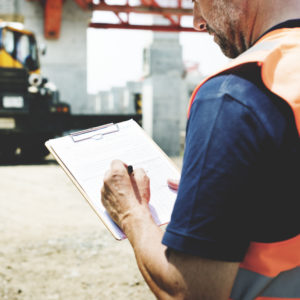 construction worker with clipboard and document