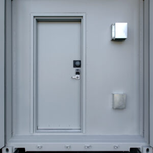 a photo of a door with a spin-dial lock on a container SCIF